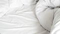 White soft bed linen with a clean duvet, creating a cozy background. Royalty Free Stock Photo