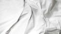 White soft bed linen with a clean duvet, creating a cozy background. Royalty Free Stock Photo