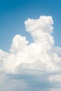 White soft cumulus congestus clouds on blue sky background.