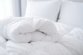 white soft duvet folded against the background of the headboard with pillows,close-up,the concept of preparing for the winter Royalty Free Stock Photo