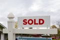White sold sign in front of a house. Real estate concept Royalty Free Stock Photo