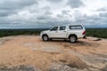 A white solitary terrain vehicle in the vastness of the African