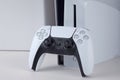 The white Sony PlayStation 5 and controller on the white table. Royalty Free Stock Photo