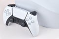The white Sony PlayStation 5 and controller on the white table. Royalty Free Stock Photo