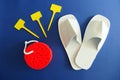 White Spa Slippers with New Red Sponge and Empty Yellow Labels isolated on Blue Background Royalty Free Stock Photo