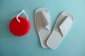 White Spa Slippers with New Red Sponge  on Blue Background Royalty Free Stock Photo