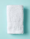 White spa towel on blue, from above Royalty Free Stock Photo