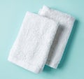 White spa towels on blue, from above Royalty Free Stock Photo