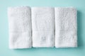White spa towels on blue, from above Royalty Free Stock Photo