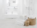 White spa towels and wicker baskets on defocused bathroom interior