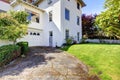 White Spanish style home with garage and backyard. Royalty Free Stock Photo