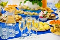 White sparkling wine in glasses. Festively laid tables at the Banquet. Various delicacies, snacks and drinks. Catering