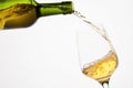 White sparkling wine pouring from green bottle. Royalty Free Stock Photo