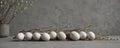White speckled eggs willow branches on grey concrete backdrop , festive, stylish, decoration Royalty Free Stock Photo
