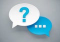 Two speech bubbles representing conversation with a question mark and ellipsis Royalty Free Stock Photo