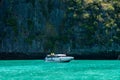 White speedboat near the rocks