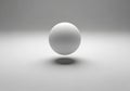 A white sphere floats in a minimalistic setting, casting a shadow Royalty Free Stock Photo