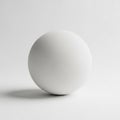 White sphere positioned on a plain surface, casting a subtle Royalty Free Stock Photo