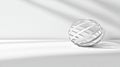 A white sphere with a silver wire pattern sits on a white surface. Royalty Free Stock Photo