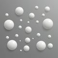 White spheres of varying sizes are arranged on a gray background, creating a 3D Royalty Free Stock Photo