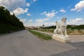 White Sphinx statue in garden with visitors sitting walking next by at Belvedere palace in Vienna, Austria