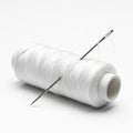 White Thread Spool With Needle Inserted On A White Background sewing craft Royalty Free Stock Photo