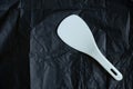 White spoon for multicooker on a black background Royalty Free Stock Photo