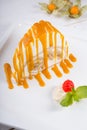 White spoonge peice of cake with orange syrup Royalty Free Stock Photo