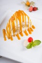 White spoonge peice of cake with orange syrup Royalty Free Stock Photo