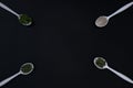 White spoons with herbs spices for cooking. On black background Royalty Free Stock Photo