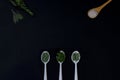 Spoons with herbs spices for cooking. On black background with copy space Royalty Free Stock Photo