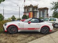 White sport car Fiat 124 Spider Abarth coupe parked