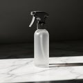 White Spray Bottle on Marble Surface Royalty Free Stock Photo