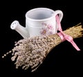 White sprinkler, watering can and a bouquet of Lavandula flowers