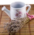 White sprinkler, watering can and a bouquet of Lavandula flowers