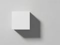 A white square casts a shadow on a gray background in a minimalist composition Royalty Free Stock Photo