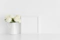 White square frame mockup with a bouquet of white roses in a vase on a white table Royalty Free Stock Photo