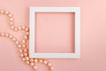 White square frame with pearl beads on a pink pearl design board Royalty Free Stock Photo