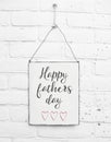 White square metal plate on white bricks background - with text happy fathers day for the best dad in de world