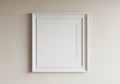 A white square object with a frame on a wall Royalty Free Stock Photo