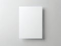 A white square object mounted on a light gray wall with a subtle shadow Royalty Free Stock Photo