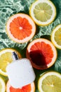 White square perfume bottle on green transparent rippled wave water surface, vertical, lemon grapefruit citrus slice