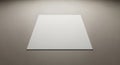A white, square piece of paper is placed on a neutral gray surface. The paper is centrall Royalty Free Stock Photo