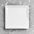 White square Plate on grey table background. Perspective view