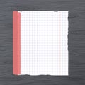 White squared ripped notebook paper sheet, sticked on gray wooden wall, desk Royalty Free Stock Photo