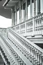 White staircase with balusters. Bright building with a beautiful staircase. Repetitive elements in architecture. Marble staircase