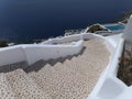 White Staircase to the Beach and Deep Blue Sea, Oia Village on Santorini Island, Greece Royalty Free Stock Photo