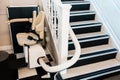 White stairlift on staircase for disabled people and elderly people indoor in home or school and office for free service