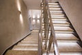 White stairs of modern building with illumination and with a handrail. Interior of the landing in a bright and stylish building Royalty Free Stock Photo