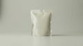 A slightly wrinkled white pouch standing upright on a white surface against a white background Royalty Free Stock Photo
